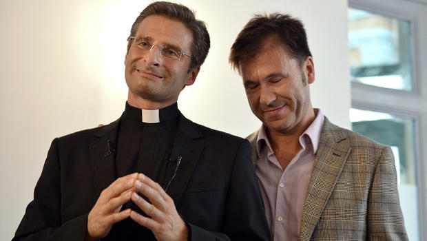 Father Krysztof Olaf Charamsa (L), who works for a Vatican office, gives a press conference with his partner Edouard to reveal his homosexuality on October 3, 2015 in Rome. The priest said he wanted to challenge what he termed the Church's "paranoia" with regard to sexual minorities, claiming the Catholic clergy was largely made up of intensely homophobic homosexuals. The Vatican condemned the coming out of a Polish priest on the eve of a major synod as a "very serious and irresponsible," act which meant he would be stripped of his responsibilities in the Church's hierarchy. In a statement, a spokesman said Krzystof Charamsa would not be able to continue in his senior position in the Vatican and that his future as a priest would be decided by his local bishop.  AFP PHOTO / TIZIANA FABI        (Photo credit should read TIZIANA FABI/AFP/Getty Images)